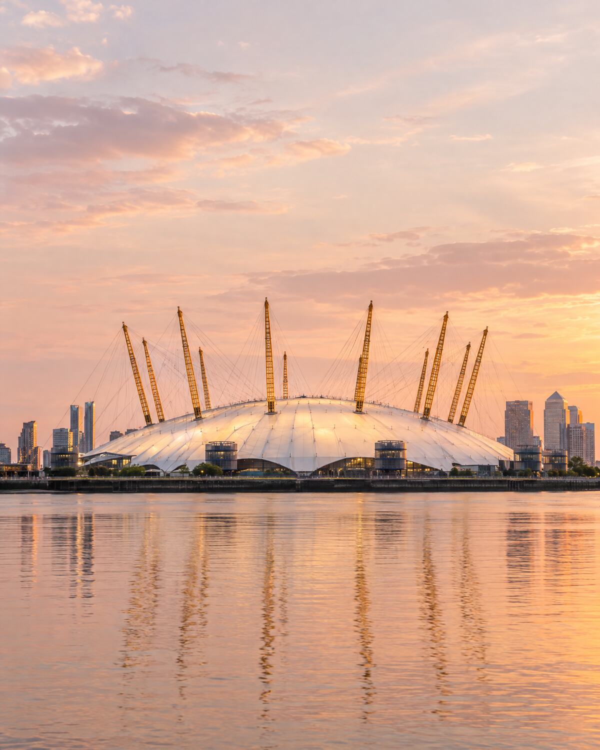 The O2 on Greenwich Peninsula at golden hour, reflected in the River Thames